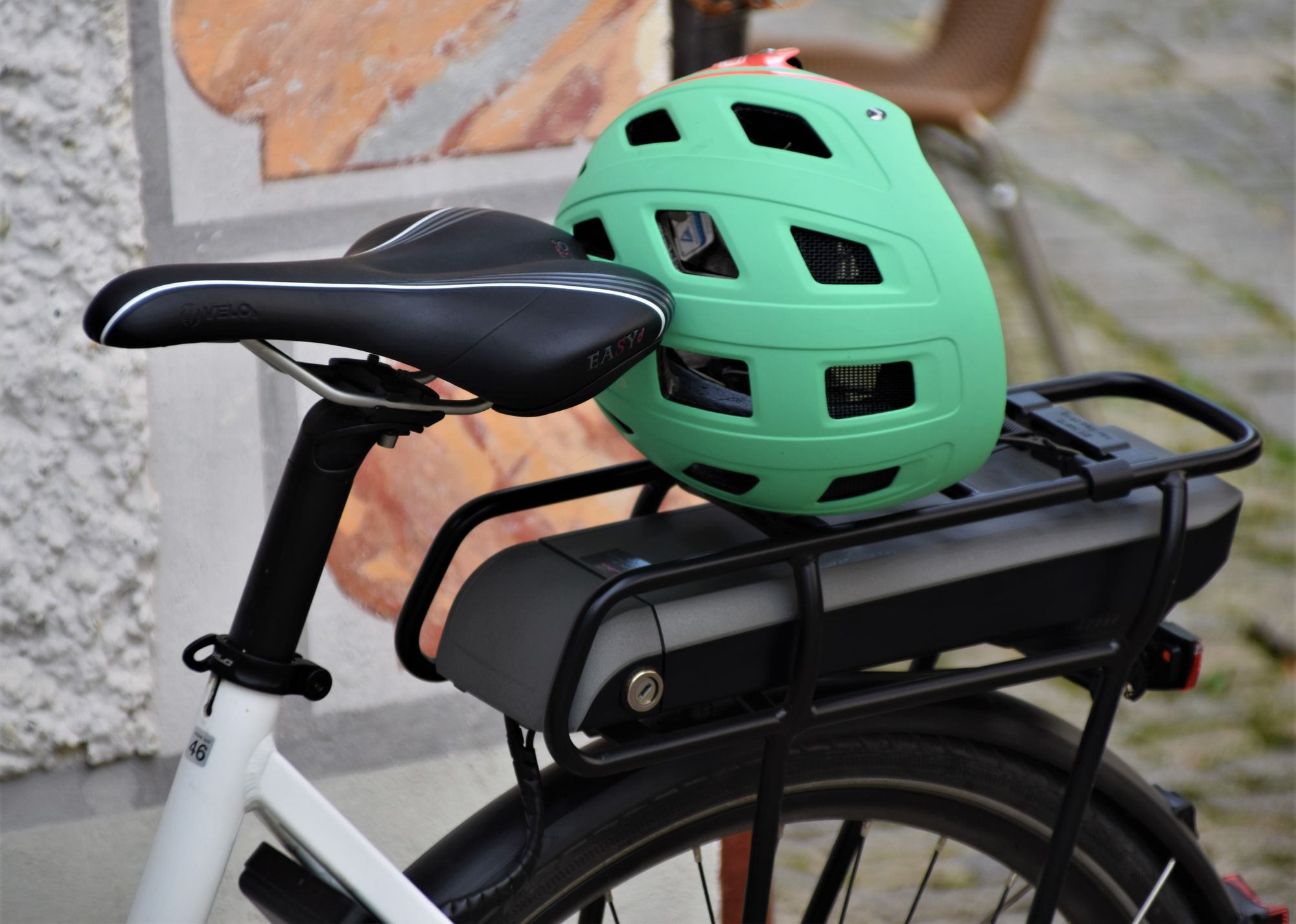 A green helmet rests on top of the bike's luggage compartment.